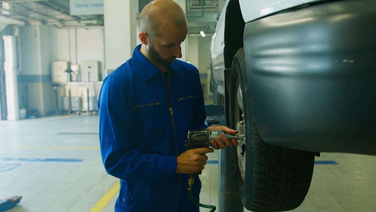 A pneumatic impact wrench connected to an air hose