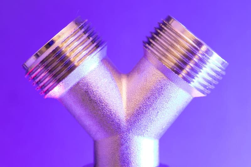 A composite-bodied safety quick-connect air coupler held in a hand