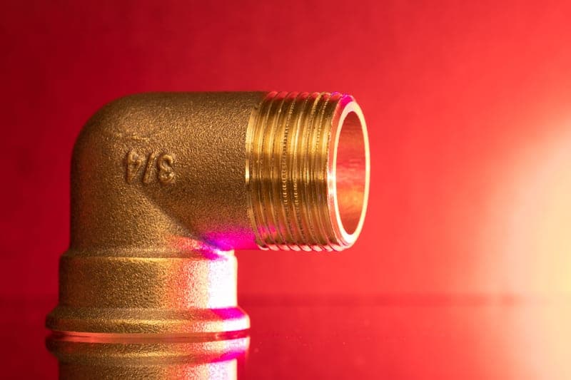 Brass air fittings, couplers and plugs arranged on a bench