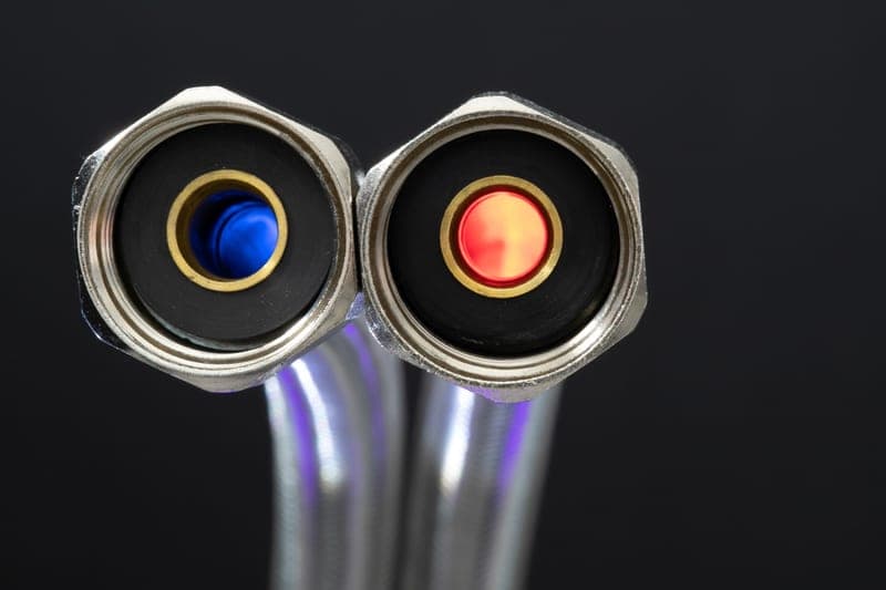 A blue polyurethane air hose coiled on a clean workshop floor