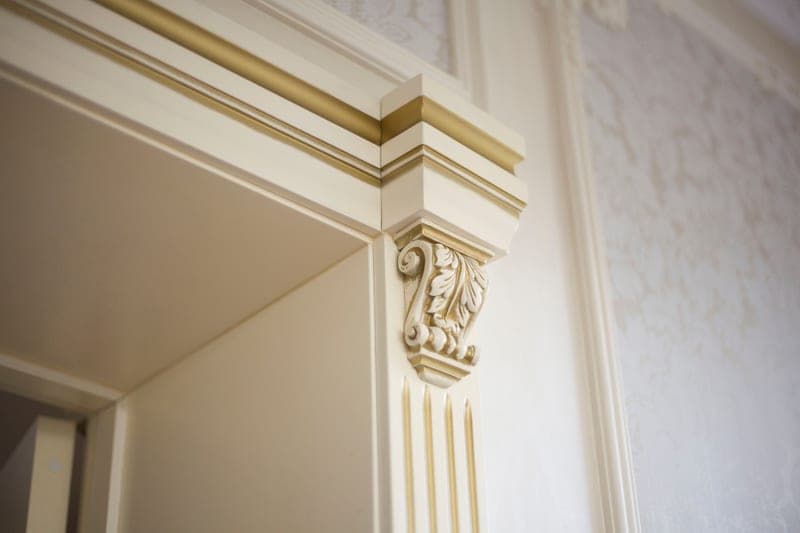 A 15-gauge angled finish nailer next to trim molding