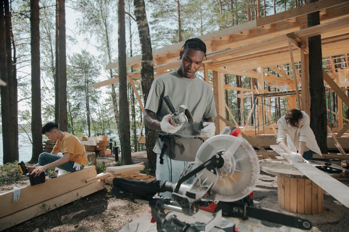 A carpenter assembling a timber frame on a deck