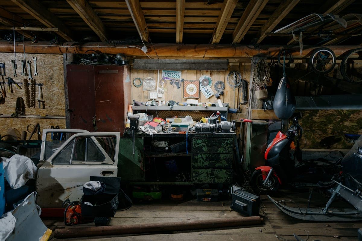 A home garage with tools and a compressor along one wall